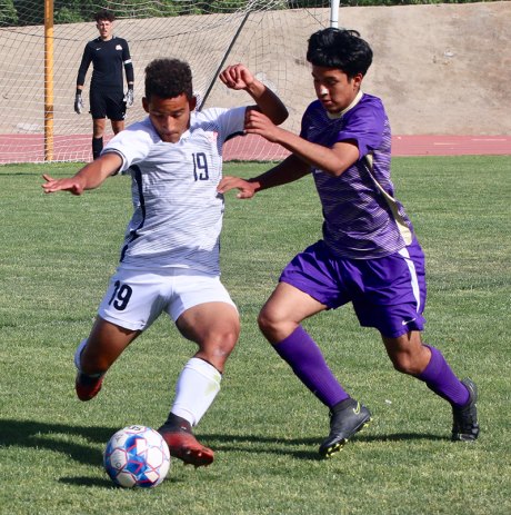 Lemoore's varsity boys' soccer edged in CIF Quarterfinals in Division 3 playoff action Thursday night in Tiger Stadium Lemoore's Jose Horta and Memorial's Christian Valdez battle for the ball during Thursday's CIV playoff game.